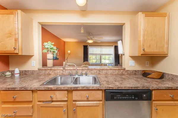 a kitchen with granite countertop a sink and a stove