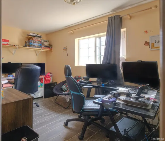 a view of a workspace with furniture and a window