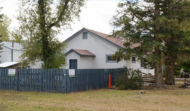 a view of a backyard with a large tree