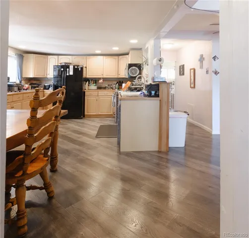 a view of kitchen with furniture and wooden floor