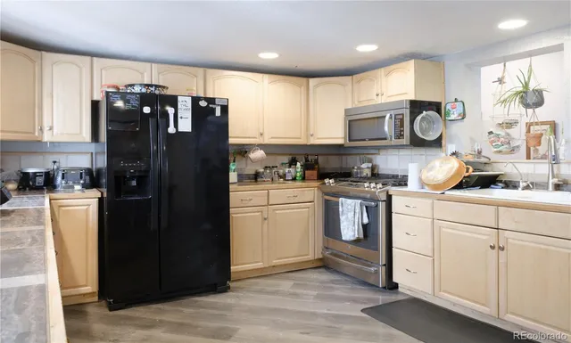 a kitchen with a refrigerator and cabinets