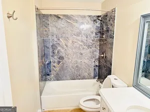 a bathroom with a bathtub and shower