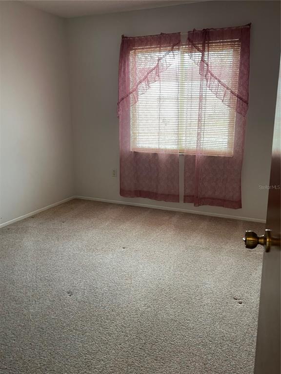 8022 Buttonball Lane Port Richey, FL 34668 - Photo 11 of 21 an empty room with a window