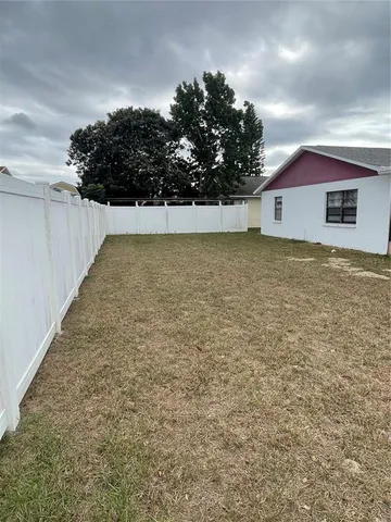 a view of house with yard and garage