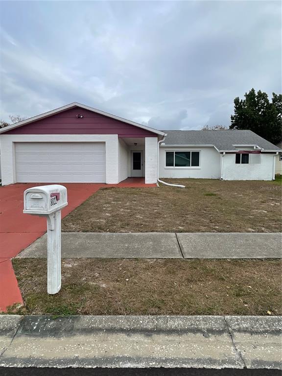 8022 Buttonball Lane Port Richey, FL 34668 - Photo 2 of 21 a front view of a house with a yard