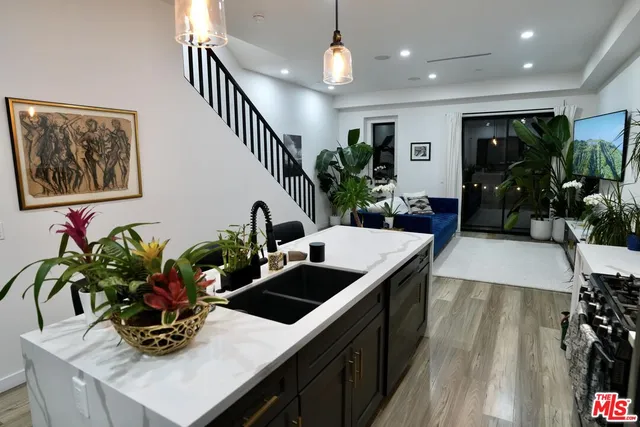 a vase of flowers sitting on a table with wooden floor