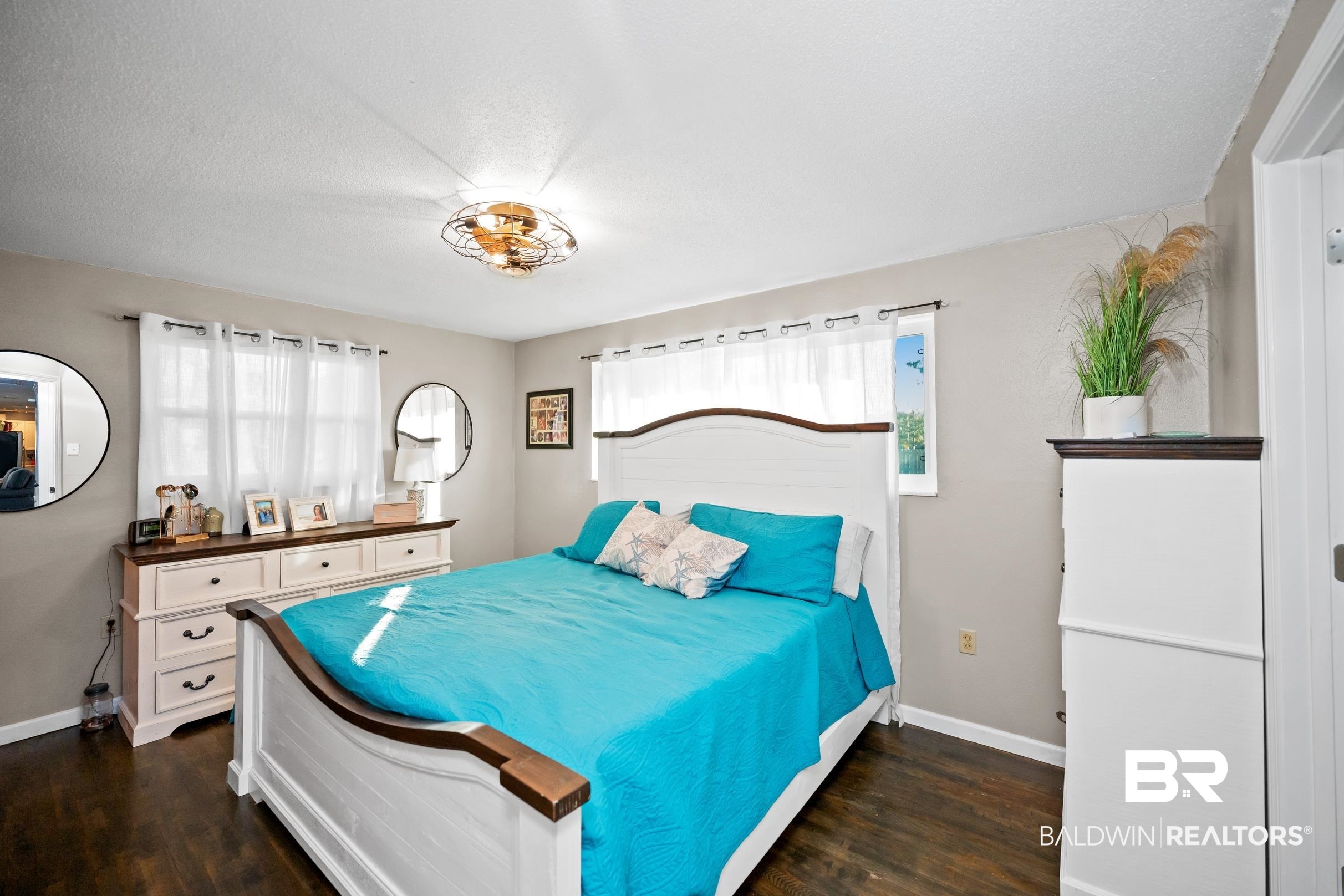 401 West Myrtle Avenue Foley, AL 36535 - Photo 22 of 39 Bedroom featuring dark wood-style flooring and a textured ceiling