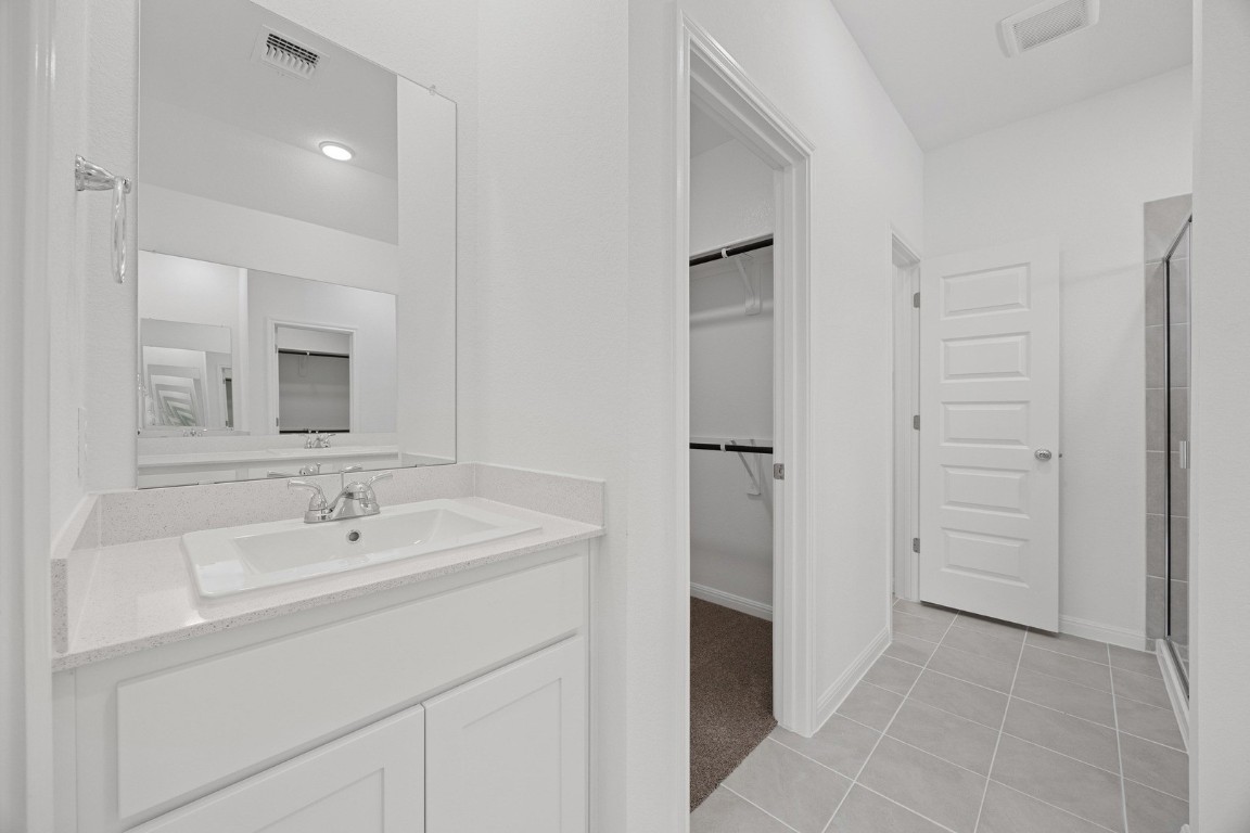 1251 Minorca Street Huffman, TX 77336 - Photo 14 of 24 a spacious bathroom with a sink and a mirror