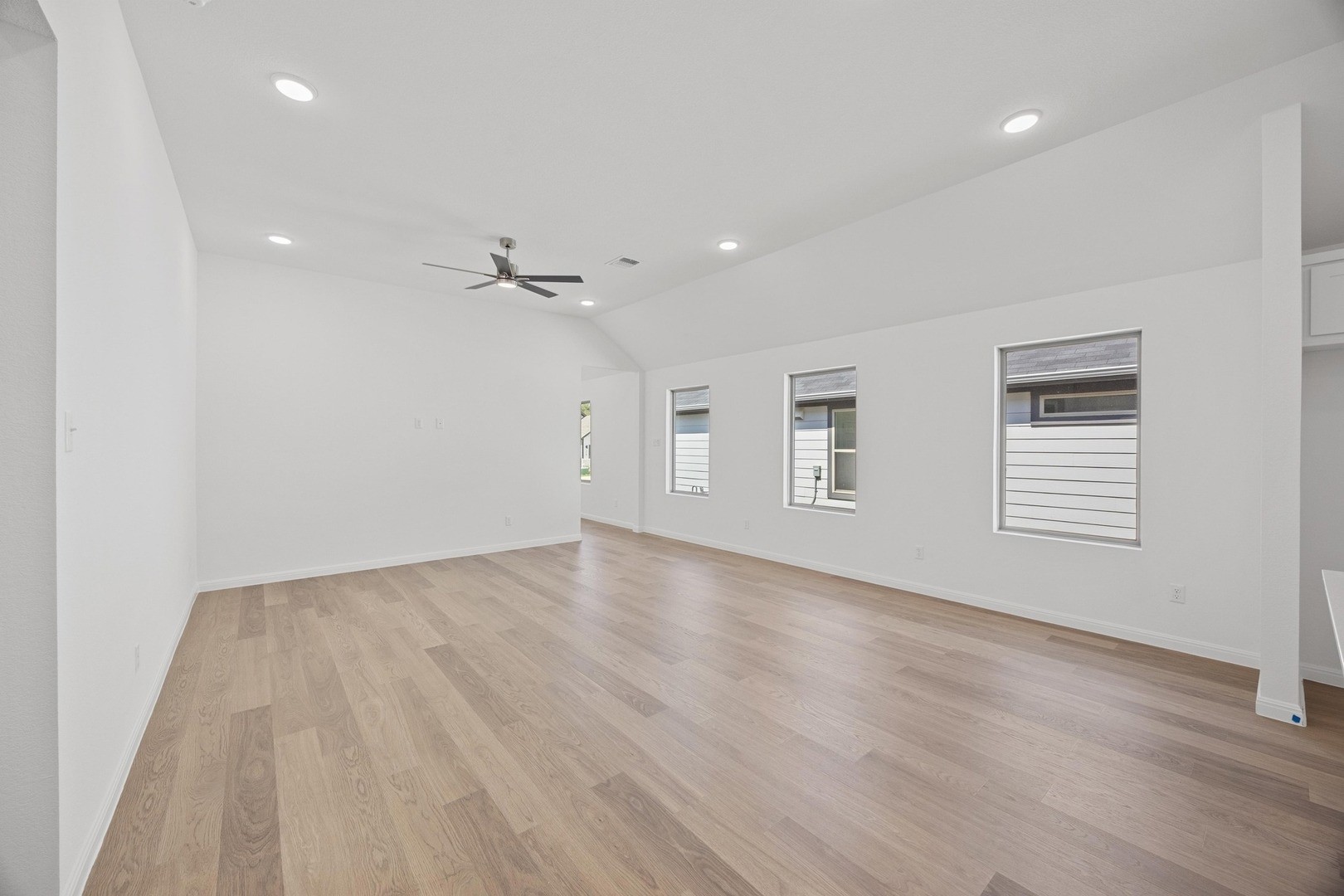 1251 Minorca Street Huffman, TX 77336 - Photo 2 of 24 wooden floor in an empty room with a window
