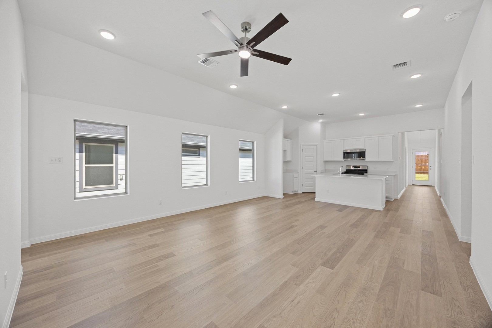 1251 Minorca Street Huffman, TX 77336 - Photo 3 of 24 a view of an empty room with a kitchen