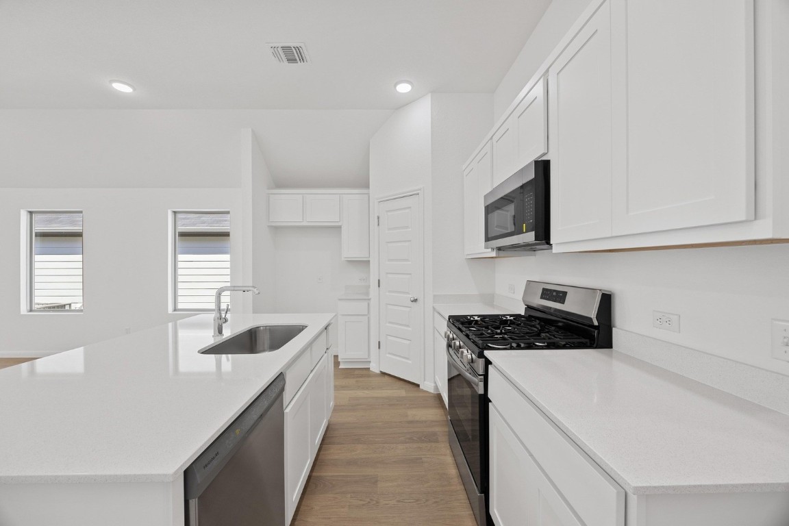 1251 Minorca Street Huffman, TX 77336 - Photo 6 of 24 a kitchen that has a microwave and a sink