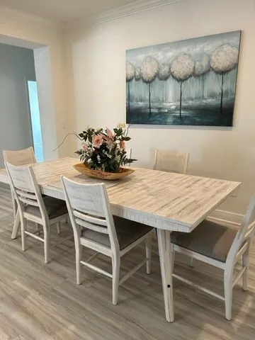 a dining room with furniture and wooden floor