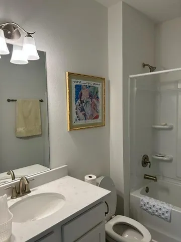 a bathroom with a sink toilet and a mirror