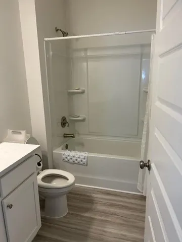 a bathroom with a toilet and a shower