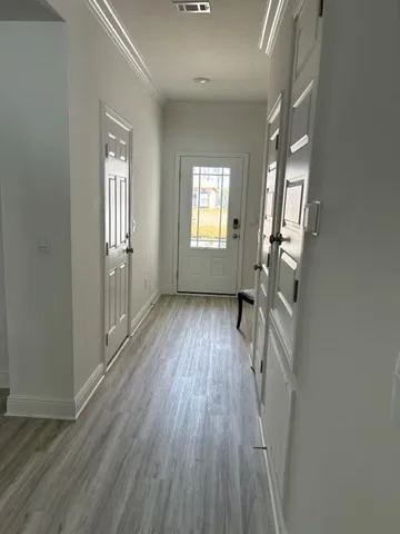 wooden floor in an empty room with a window