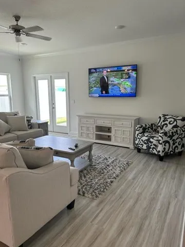 a living room with furniture and a flat screen tv