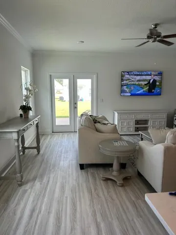 a living room with furniture and a wooden floor