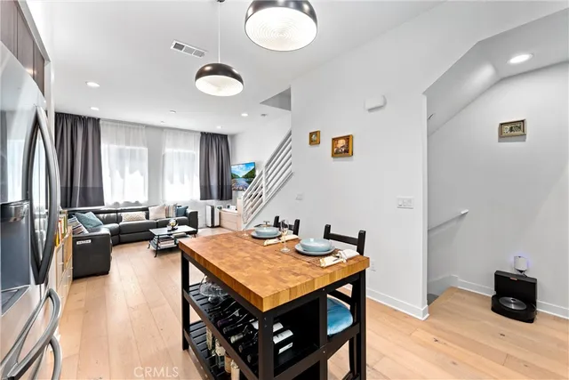 a very nice looking living room with dining room and wooden furniture