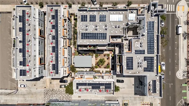 a front view of a building with large trees