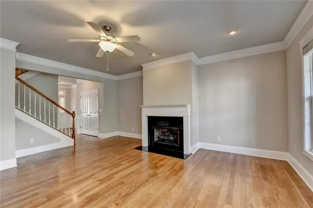 a view of a kitchen with a sink dishwasher a kitchen island with wooden floor and cabinets