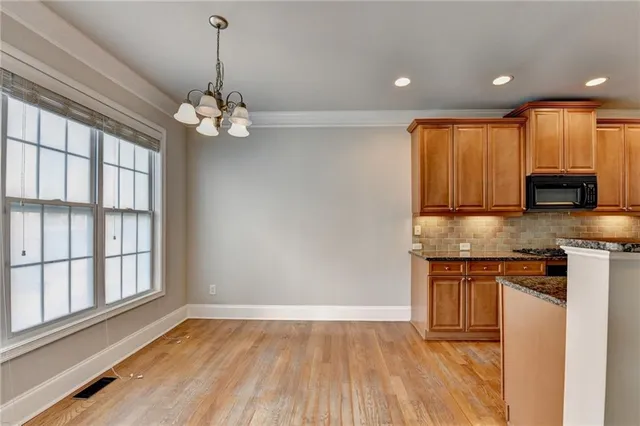 a kitchen with stainless steel appliances granite countertop a stove and a refrigerator