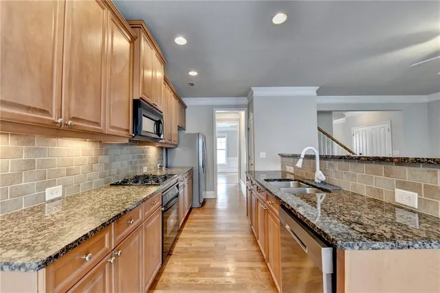 a kitchen with a stove sink and microwave