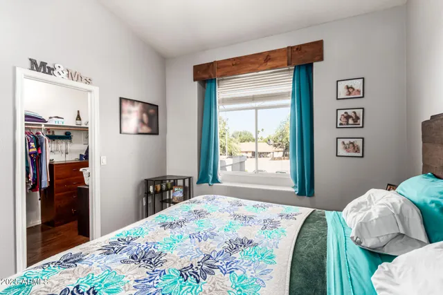 a bedroom with a bed and a window