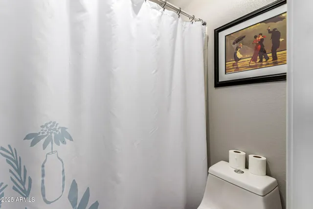 a bathroom with a shower and a sink