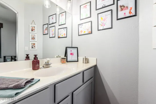 a kitchen with a sink cabinets and wooden floor