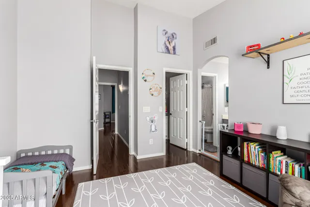 a bedroom with a bed and a book shelf