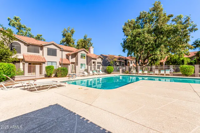 a swimming pool with outdoor seating and yard