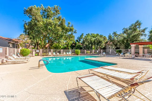 a view of house with swimming pool yard