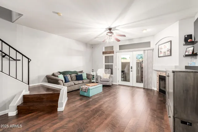 a living room with fireplace furniture and a wooden floor