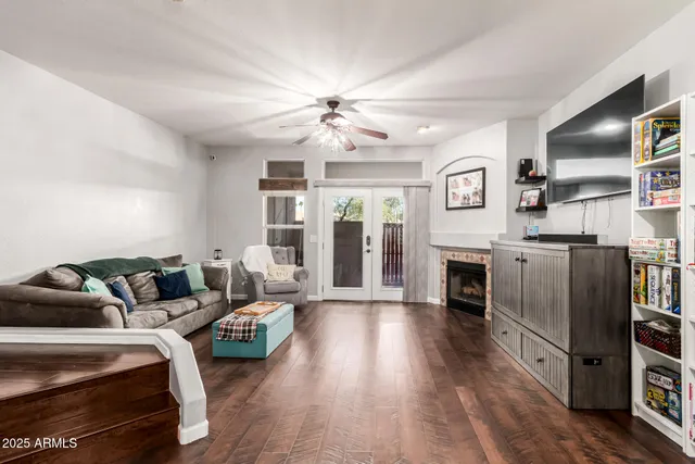 a living room with furniture fireplace and flat screen tv