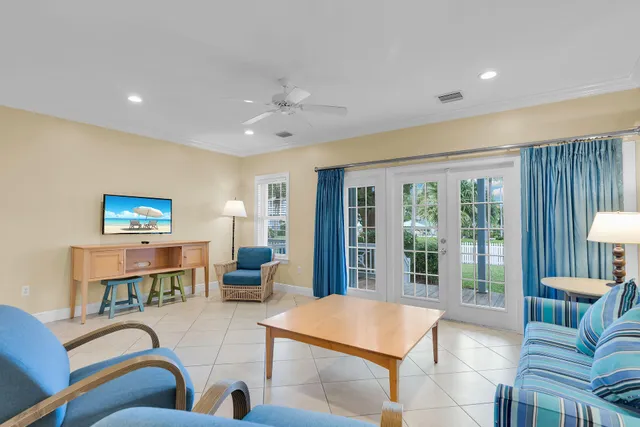 a living room with furniture a rug and a chandelier