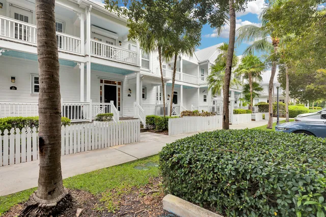 a kitchen with stainless steel appliances granite countertop a stove top oven a sink dishwasher a dining table and chairs with wooden floor