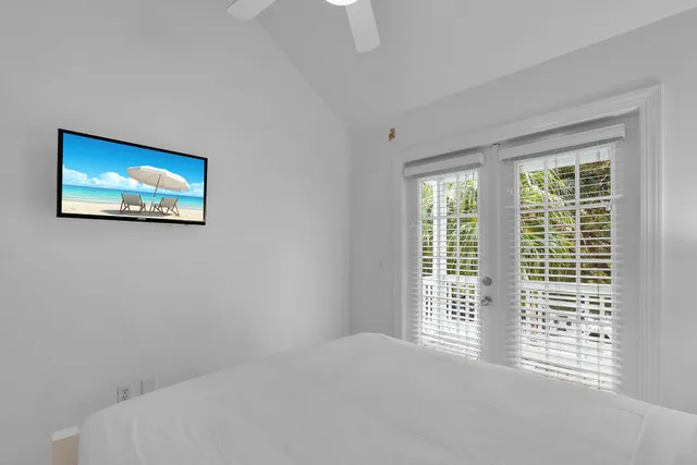a walk in closet with wooden floor