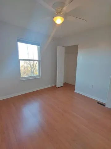 an empty room with windows and closet