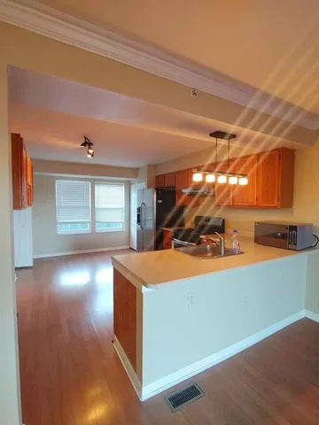 a view of a room with window and kitchen view