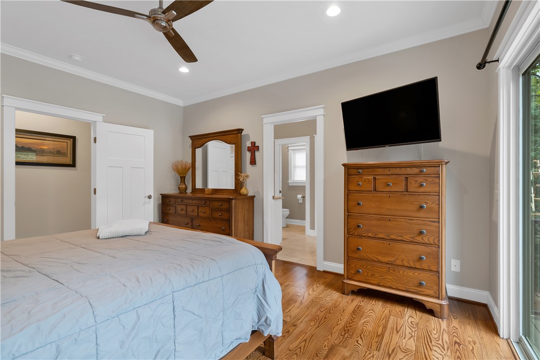 329 High Hampton Road Salem, SC 29676 - Photo 21 of 47 Rich hardwood floors and classic crown molding elevate this serene bedroom suite.