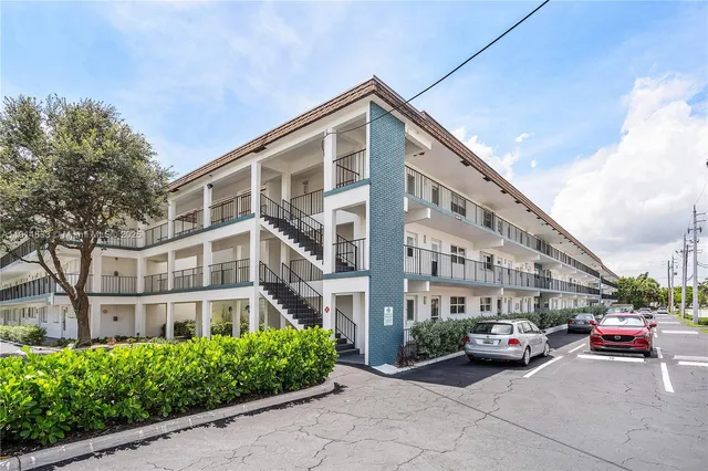 a city street lined with parked cars and buildings