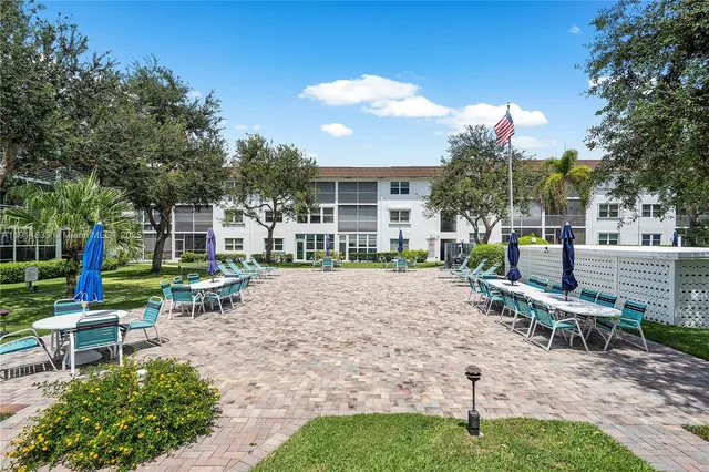 a view of a backyard with sitting area