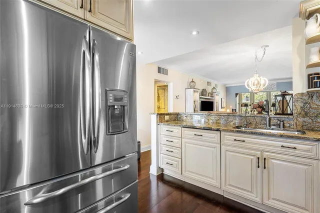 a kitchen with stainless steel appliances a refrigerator and a sink