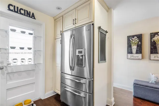 a metallic refrigerator freezer sitting in a kitchen
