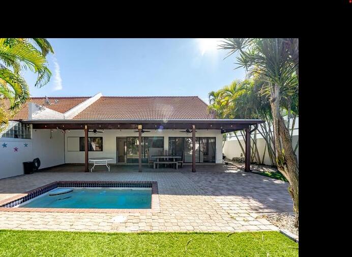a view of a house with backyard porch and sitting area