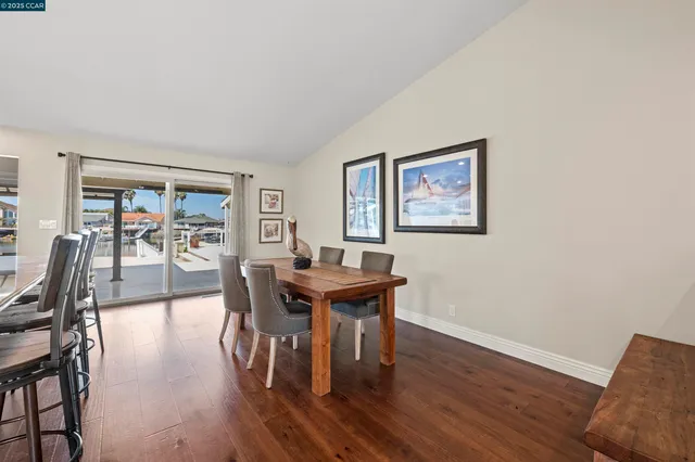 a large kitchen with lots of counter space a sink appliances and dining room view