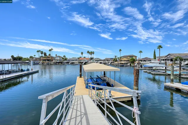 a view of a patio with lawn chairs under an umbrella