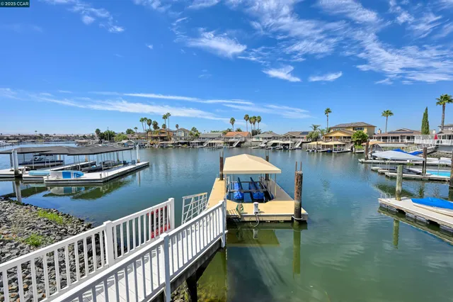 an aerial view of a house with swimming pool and outdoor seating