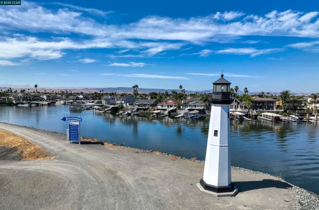an aerial view of a house with a yard and lake view