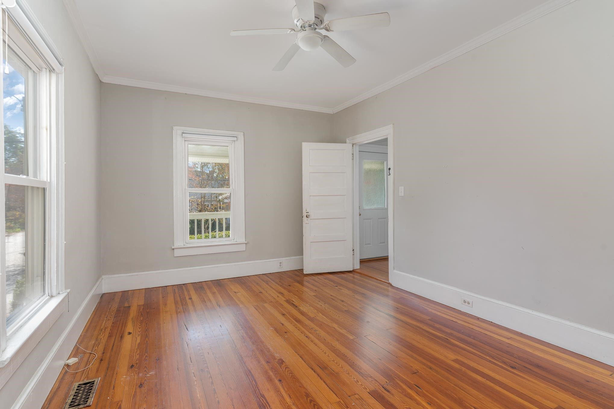 519 Holden Street Raleigh, NC 27604 - Photo 13 of 23 a view of an empty room with wooden floor and a window